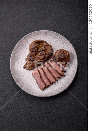 Juicy beef steak grilled with salt, spices and herbs 120552050