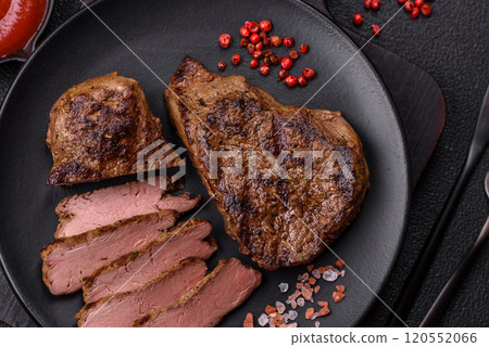 Juicy beef steak grilled with salt, spices and herbs 120552066