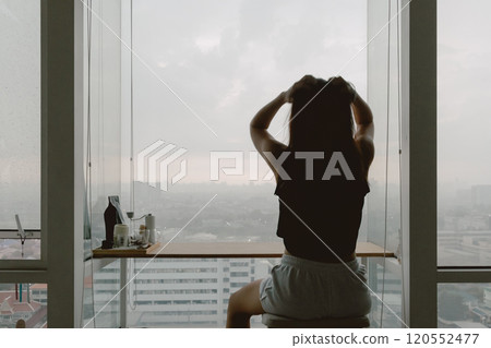 Woman relaxed at her windows apartment, enjoy the view and time. Woman relaxed at her windows apartment, enjoy the view and time. 120552477