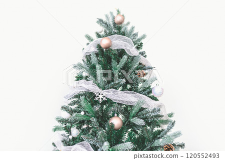 Decorated Christmas pine tree decorated with white gold ornaments and garlands isolated on white wall cerebrate for happy holiday and new year. Decorated Christmas pine tree decorated with white gold ornaments and garlands isolated on white wall cerebrate for happy holiday and new year. 120552493