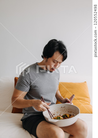 Man eating his homemade diet meal in the pan as it is his daily routine. 120552498