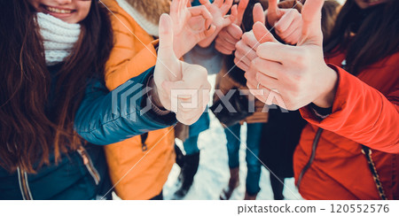 Hands of young people in the winter.Winter children in the yard playing with snow in the park 120552576