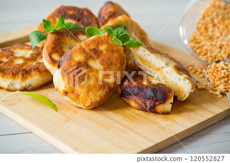 cooked fried pea pies on a wooden board cooked fried pea pies on a wooden board 120552827