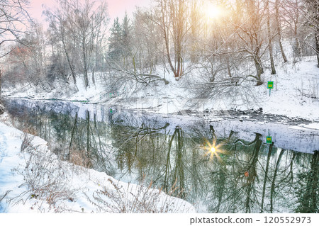 Fantastic landscape in city park with snowy trees and beautiful frozen river. Fantastic landscape in city park with snowy trees and beautiful frozen river. 120552973