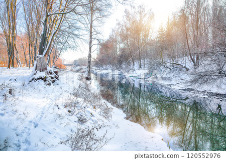 Fabulous landscape in city park with snowy trees and beautiful frozen river. Fabulous landscape in city park with snowy trees and beautiful frozen river. 120552976