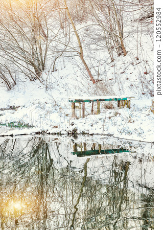 Breathtaking landscape in city park with snowy trees and beautiful frozen river. Breathtaking landscape in city park with snowy trees and beautiful frozen river. 120552984