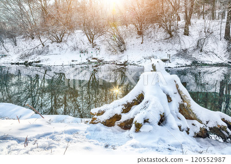 Breathtaking landscape in city park with snowy trees and beautiful frozen river. Breathtaking landscape in city park with snowy trees and beautiful frozen river. 120552987