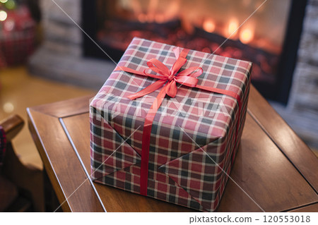 Armchair with plaid, packing gift boxes for family near christmas tree and fireplace. Top view 120553018