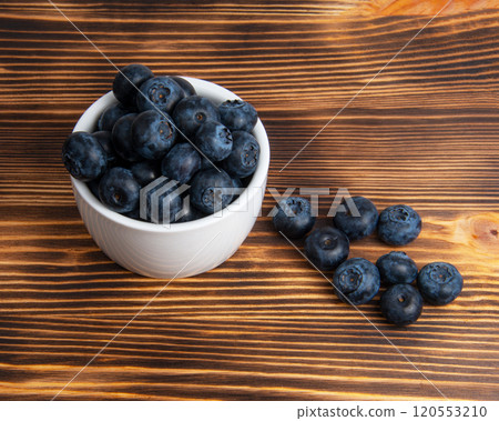 Fresh blueberry in white dish on wooden background Fresh blueberry in white dish on wooden background 120553210