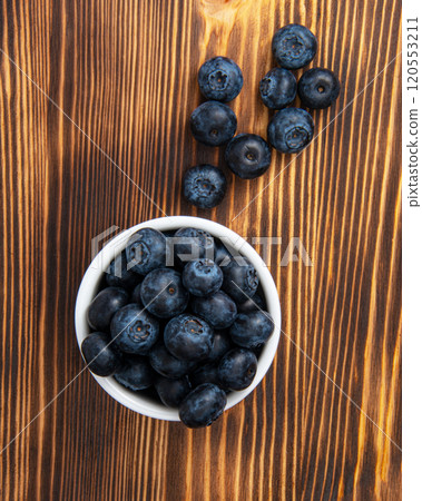 Fresh blueberry in white dish on wooden background 120553211