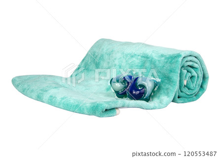 Colorful gel washing capsule on green fabric isolated on the white background 120553487