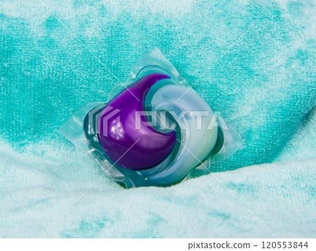Colorful gel capsule for washing on blue green material soft background Colorful gel capsule for washing on blue green material soft background 120553844