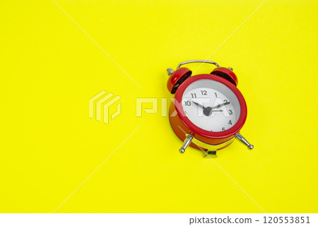 Red alarm clock on yellow background with copy space Red alarm clock on yellow background with copy space 120553851