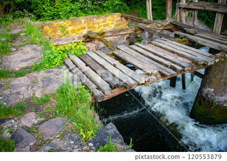 Old vintage wooden bridge in green forest Old vintage wooden bridge in green forest 120553879