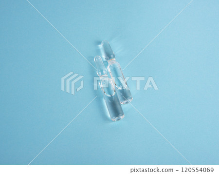 Medical ampoule on blue background Medical ampoule on blue background 120554069