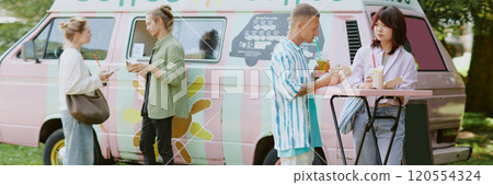 Website banner with people enjoying beverages and food from food truck behind them 120554324