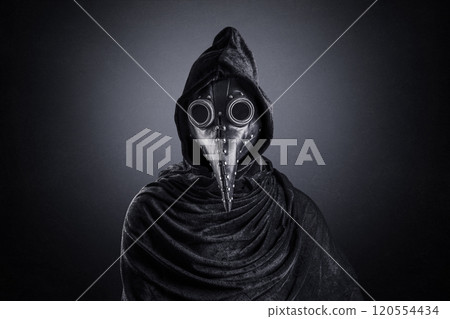 Plague doctor in hooded cloak at night over dark misty background Plague doctor in hooded cloak at night over dark misty background 120554434