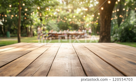 An empty wooden table with a garden party 120554703