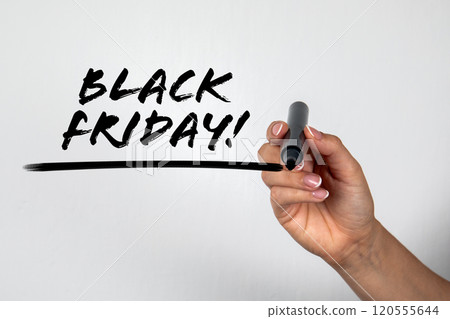 Black Friday. Woman's hand with a black marker writes on the screen 120555644