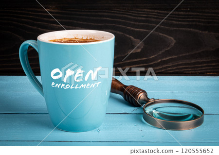 Open Enrollment. Coffee mug with text on a wooden table 120555652