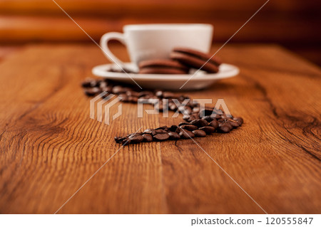Coffee beans and a cup of coffee.cup of coffee and beans on dark background, top view Coffee beans and a cup of coffee.cup of coffee and beans on dark background, top view 120555847
