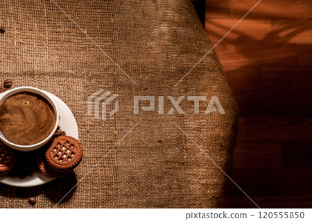 Coffee beans and a cup of coffee.cup of coffee and beans on dark background, top view Coffee beans and a cup of coffee.cup of coffee and beans on dark background, top view 120555850