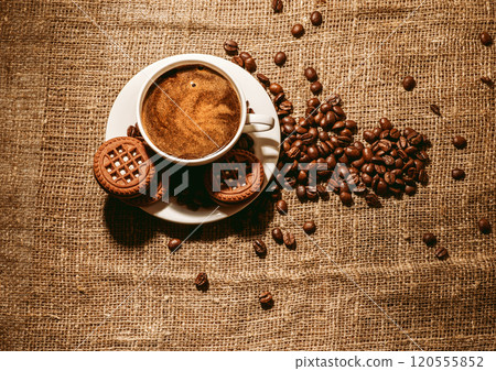 Coffee beans and a cup of coffee.cup of coffee and beans on dark background, top view 120555852
