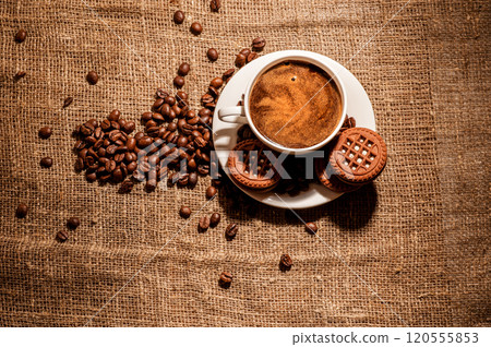 Coffee beans and a cup of coffee.cup of coffee and beans on dark background, top view 120555853