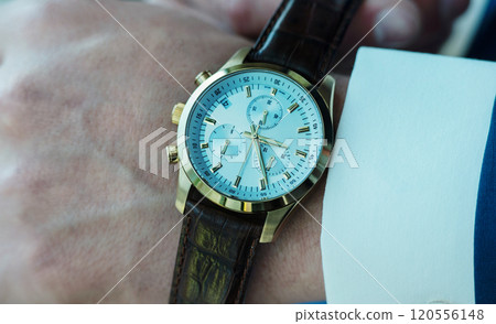 Businessman pointing at hand watch 120556148