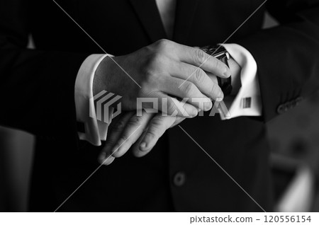 Hours on hands. Businessman looking at his watch in office 120556154