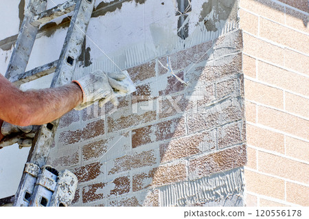 Facade cladding with decorative protective panels of fake brickwork. 120556178