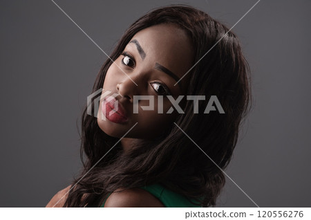 Beautiful sensual young woman with dark fashion make-up, isolated on blue.Beautiful mulatto portrait. stylish sexy. 120556276