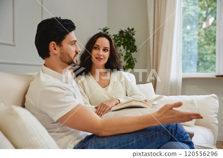 Couple engaged in meaningful conversation while relaxing at home Couple engaged in meaningful conversation while relaxing at home 120556296