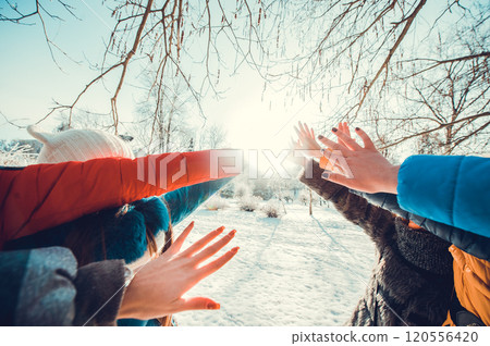 A group of little boys and girls in colorful clothes play outdoors during snowfall. Active vacation with children in winter on cold days. Happy siblings and twins having fun with snow A group of little boys and girls in colorful clothes play outdoors during snowfall. Active vacation with children in winter on cold days. Happy siblings and twins having fun with snow 120556420