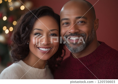 A happy couple smiling warmly, standing together with festive lights in the background A happy couple smiling warmly, standing together with festive lights in the background 120556603