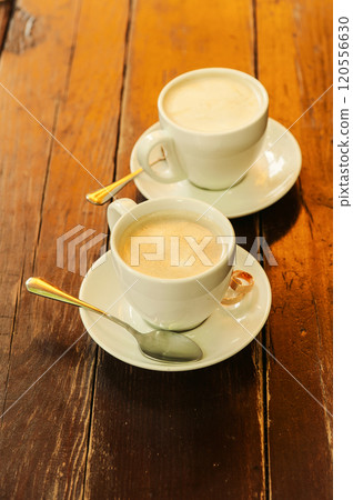 A cup of coffee on a wooden table 120556630