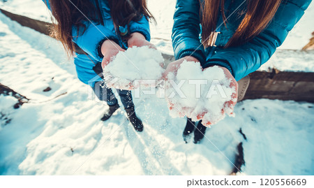A group of little boys and girls in colorful clothes play outdoors during snowfall. Active vacation with children in winter on cold days. Happy siblings and twins having fun with snow A group of little boys and girls in colorful clothes play outdoors during snowfall. Active vacation with children in winter on cold days. Happy siblings and twins having fun with snow 120556669