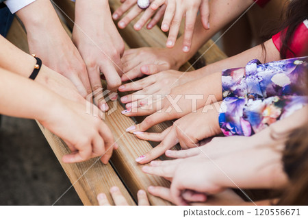Hands of young people in the nature, team concept.a group of people shake their hands at once.Hands of young people Hands of young people in the nature, team concept.a group of people shake their hands at once.Hands of young people 120556671