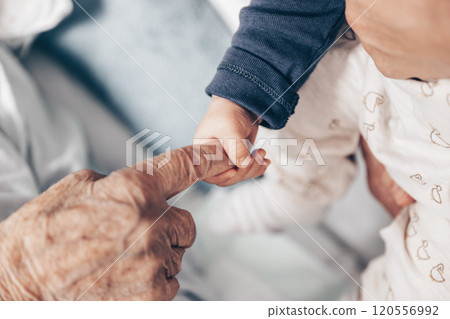 Circle of life. Little baby boy child hand holding great grandmother wrinkled finger. Intergenerational help and solidarity concept. Circle of life. Little baby boy child hand holding great grandmother wrinkled finger. Intergenerational help and solidarity concept. 120556992