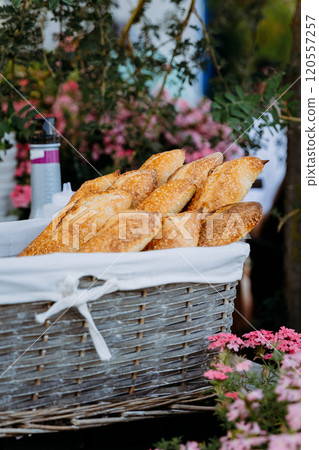 Freshly baked baguettes in a rustic basket, perfect for breakfast or dinner, surrounded by nature 120557257