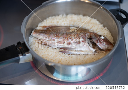 Making sea bream rice in a pressure cooker Making sea bream rice in a pressure cooker 120557732