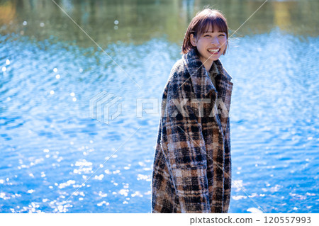 Young woman strolling through the autumn/winter park Young woman strolling through the autumn/winter park 120557993