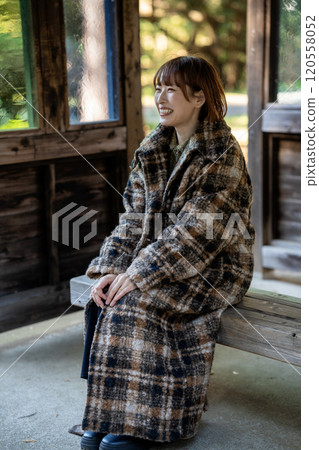 A woman sitting on a bench A woman sitting on a bench 120558052