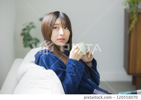Young woman relaxing in a room Young woman relaxing in a room 120558070