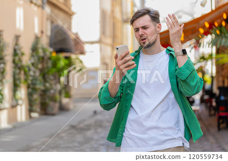Sad man using smartphone browsing loses lottery casino application results bad news fail virus Sad man using smartphone browsing loses lottery casino application results bad news fail virus 120559734