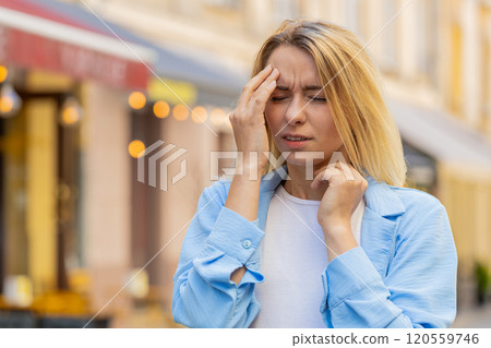 Displeased exhausted woman rubbing temples to cure headache problem suffering from tension migraine 120559746