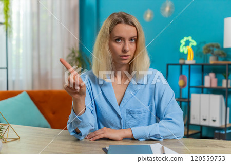 Business woman shakes finger saying No be careful avoid danger mistake disapproval sign at office 120559753