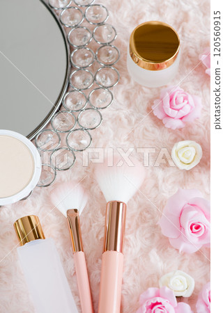 A makeup image before going out, with makeup accessories and roses placed on top of fur fabric. A makeup image before going out, with makeup accessories and roses placed on top of fur fabric. 120560915