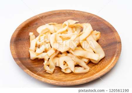 Smoked squid slices on a wooden plate (ikakun) Smoked squid slices on a wooden plate (ikakun) 120561190