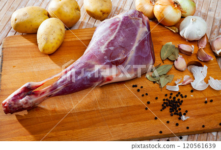 Raw lamb leg with potatoes and condiments 120561639